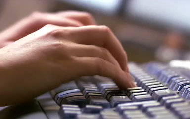 keyboard with hands typing 